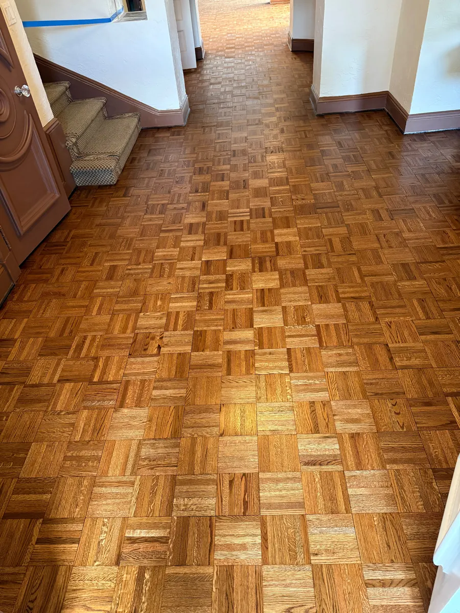 Parquet floor sanded down to bare wood, ready for finish