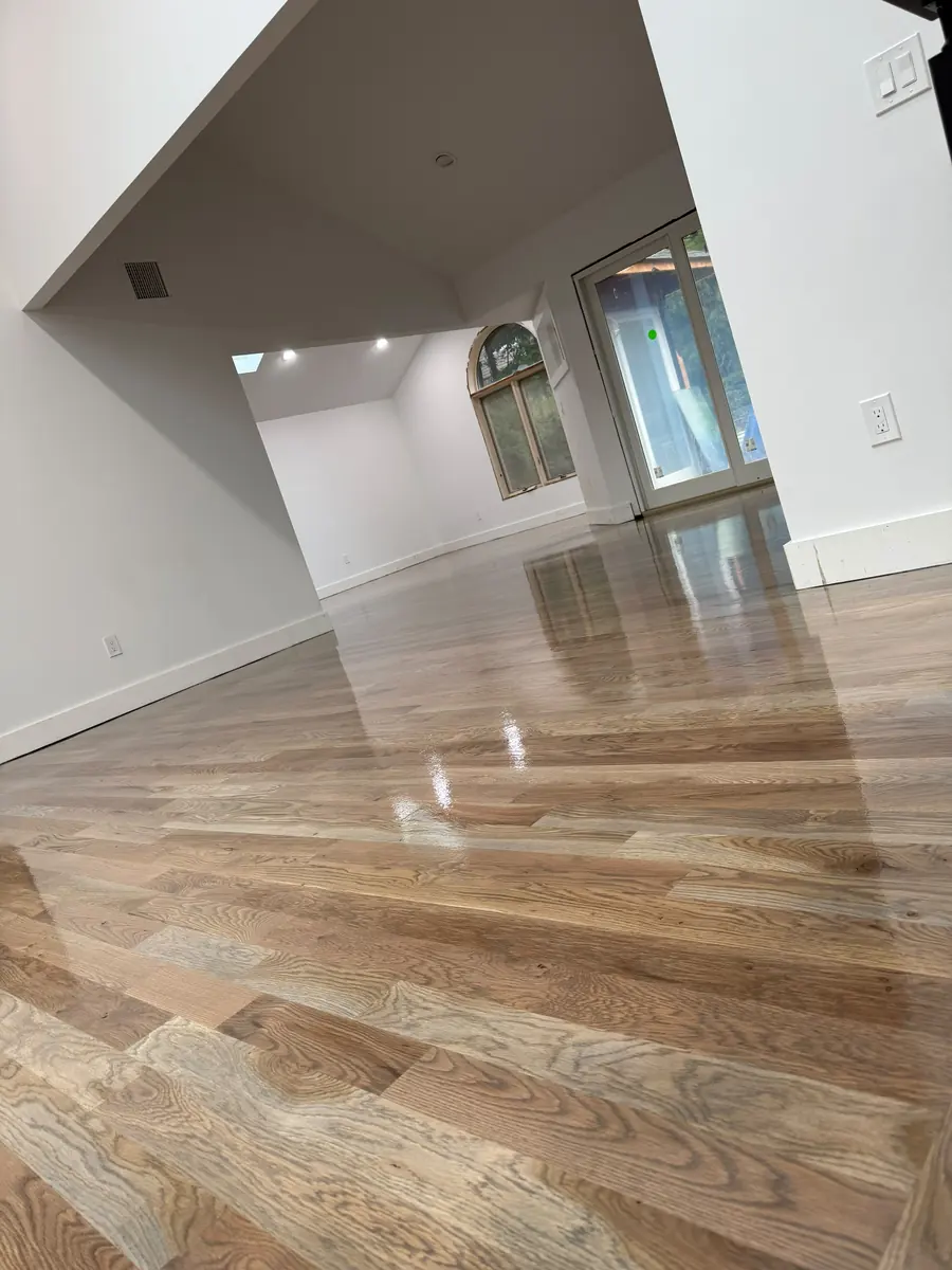 Finished wide plank hardwood floor in a large living room