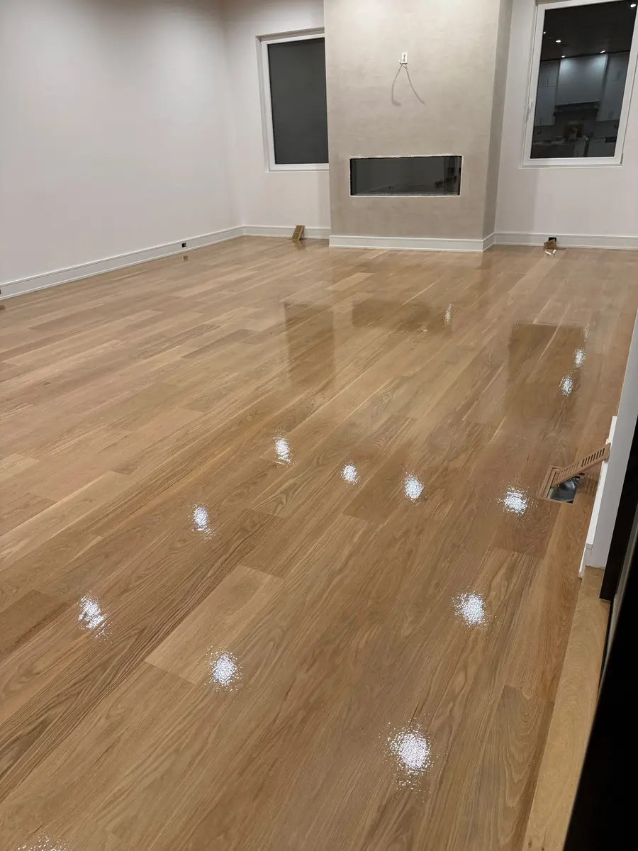 Finished light hardwood floor in an open living space