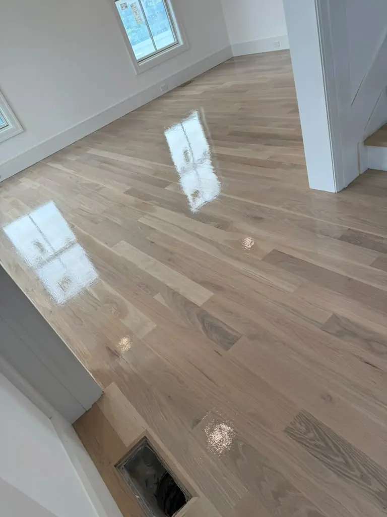 Finished hardwood floor by the stairs