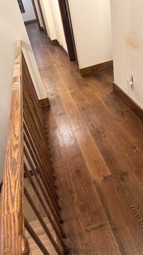 Finished dark stained hardwood hallway and stairs